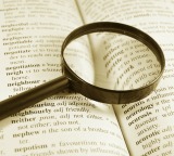 Magnifying glass on dictionary